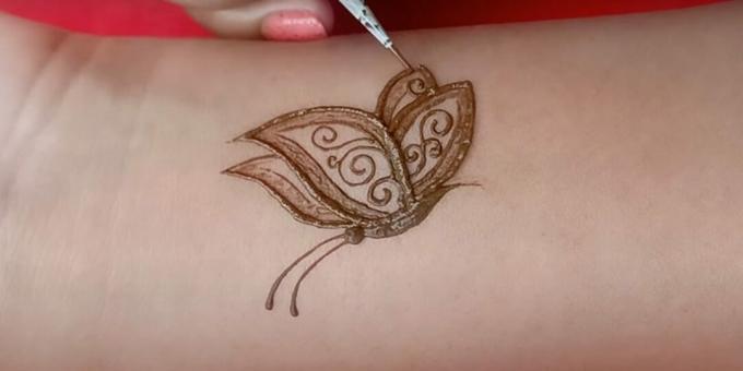 Henna fjärilsteckning på handen: skildra mönstret och antennerna